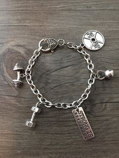 "*10% of net profits from the sale of this product will be donated to help preserve marine life.* Need some motivation while working toward your fitness goal? This inspirational bracelet will help you keep your eye on the prize! Also makes a great gift!  Includes 6 fitness related charms (see pic above) on a matching silver tone chain bracelet (one size fits all).  Materials: Zinc alloy metal. Lead and nickel free.  Measures: Approximately 7.7/8\" from end of lobster claw to the tip of the last Strong Is Beautiful, Glam Gifts, Fitness Goal, Inspirational Bracelets, Bodybuilding Fitness, Colorful Jewelry, Kettlebell, Personal Trainer, Beautiful Bracelet