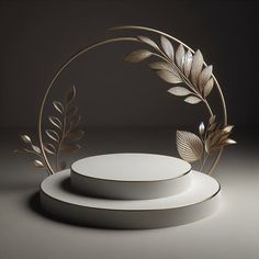 two white plates sitting on top of each other next to a gold leaf design decoration