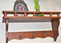 a wooden shelf with two pictures on it