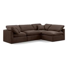 a brown sectional couch with pillows on it