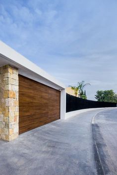 an empty driveway with a large garage door