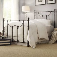 a bed with white sheets and pillows in a bedroom