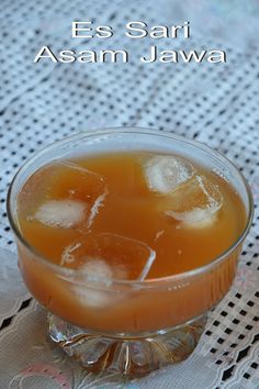 a glass filled with liquid sitting on top of a table