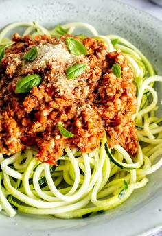 a white plate topped with spaghetti and meat sauce