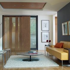 a living room with a couch, coffee table and sliding glass doors