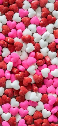 heart shaped candies are arranged in pink and white