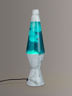 a white marble lamp with blue and green lights on the top, sitting on a gray surface