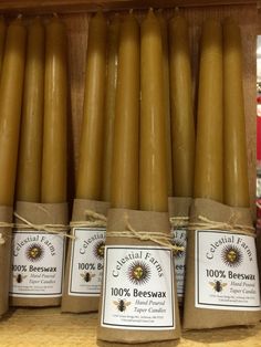 several beeswax candles are wrapped in brown paper