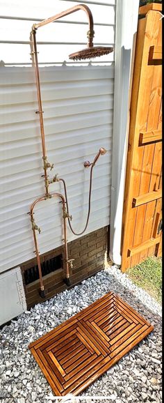 a shower head and hose attached to the side of a house