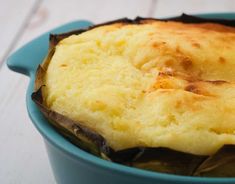 a casserole in a blue dish on a white table