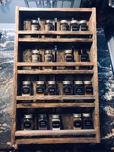 a wooden shelf filled with lots of jars