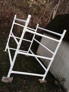 a white metal bed frame sitting in the grass