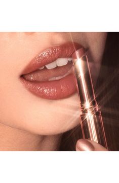 What it is: A sumptuous, star-lit glossy lipstick for kiss-worthy, wider-looking lips.What it does: This gloss delivers full, pillowy lips. It's formulated with polymers, which create an excellent soft, elegant, silk-feeling film to enhance wear, imparting a luscious, wet, shiny glossy finish. Brilliant emollient oil leaves lips with a heavy gloss, while magic diamond powder provides sparkling photoluminescence. Hyaluronic acid hydrates your lips.How to use: Swipe onto lips directly from the bul Charlotte Tilbury Superstar Lips, Glossy Lipstick, Peach Lipstick, Mascara Set, Glossier Lipstick, Sheer Lipstick, Kim K Style, Jessie James, Natural Lipstick