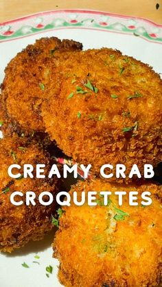 three crab cakes on a plate with the words creamy crab croquettes