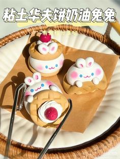 three small cupcakes are sitting on a paper plate with forks and spoons