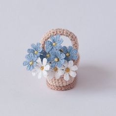 small crocheted basket with blue and white flowers