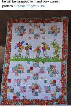 a quilted wall hanging with giraffes and flowers in the grass on it