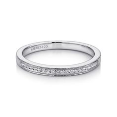 a white gold wedding band with princess cut diamonds on the sides and pave detailing