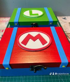 two wooden boxes with the letter m on them