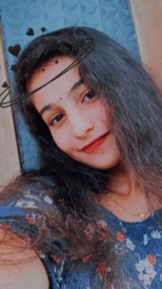 a young woman with long hair posing for a photo