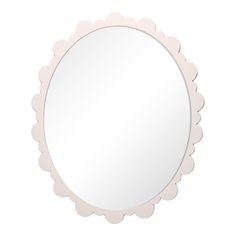 a white round mirror with scalloped edges