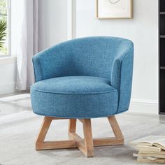 a blue chair sitting on top of a white rug next to a book shelf and window