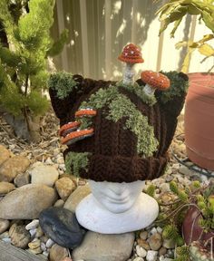 a crocheted hat with mushrooms on it