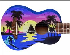 an acoustic guitar painted with the image of a sunset and palm trees on it's body