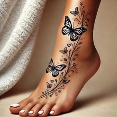 a woman's foot with butterflies on it