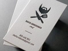 two business cards with scissors and a beard on them are sitting next to each other