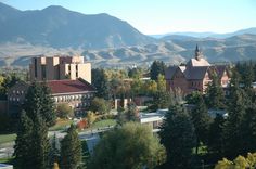 an aerial view of a campus with mountains in the background