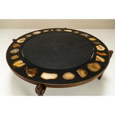 a black and brown table with different types of shells on the top, sitting on a white surface