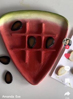 a slice of watermelon with holes in the middle and chocolates on the side