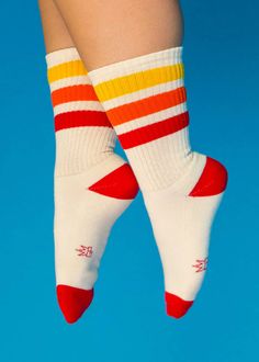 All accessories are final sale Takin' it back to the '70s and '80s with these retro socks! Features a more relaxed fit for ultimate comfort and a gentle feel around the calf. Wear them pulled up or scrunched down. Made of natural cotton with accents of red, orange, and yellow nylon. Super comfy, unisex, one-size-fits-most, and made in the USA. Note: Cream portion is made of natural cotton, so lil darker specks in the fabric will occur. Features: Unisex Gym Crew Socks Wide Rib knit Cushioned foot Retro Socks, Retro Gym, Sock Lovers, Ankle Length Skirt, Funny Socks, Botanical Wedding, Novelty Socks, Orange And Yellow, Autumn Summer