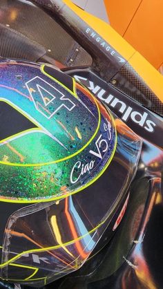 a close up of the side of a racing car with colorful paint on it's face