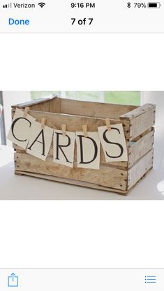 a wooden crate filled with cards on top of a table