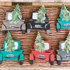 a wooden tray with christmas trees and cars on it