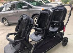 two baby strollers sitting next to each other in front of a silver van on the street