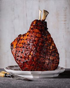 a piece of meat sitting on top of a white plate