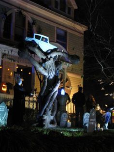 halloween decorations in front of a house at night