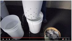 two buckets are sitting next to each other on the ground and one is filled with water