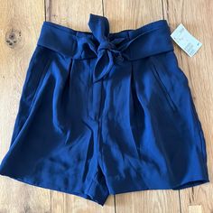 High Waisted Dark Navy Blue Shorts With Bowtie In Front And So Pockets On The Sides And In The Back. Brand New With Tags. Navy High Waist Shorts For Summer, Navy High-waist Shorts For Summer, H&m High Waist Bottoms For Day Out, Blue Summer Shorts With Belt Loops, Blue Shorts With Belt Loops For Summer, Blue Shorts With Belt Loops For Day Out, Chic High Waist Shorts By H&m, Blue Paperbag Waist Shorts With Pockets, Blue Shorts By H&m