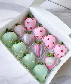 a box filled with chocolate covered strawberries sitting on top of a marble countertop