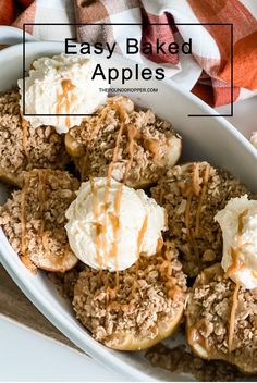 baked apples with caramel drizzle and whipped cream in a white dish on a wooden table