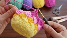 someone is crocheting a heart with yarn