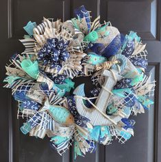 a blue and white wreath with an anchor, starfish, and fish on it