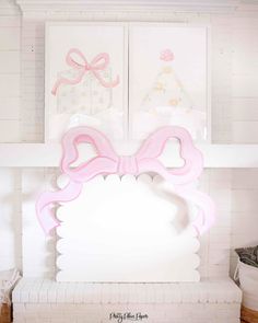 a white fireplace with pink bows on it