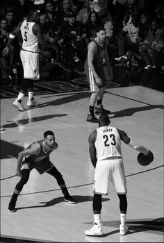 black and white photograph of basketball players on court