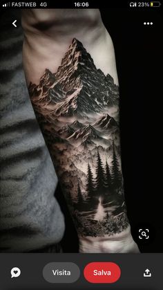 a man's arm with a mountain and trees tattoo on the left side of his arm