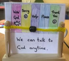 a sign that says we can talk to god anytime with two wooden pegs attached to it